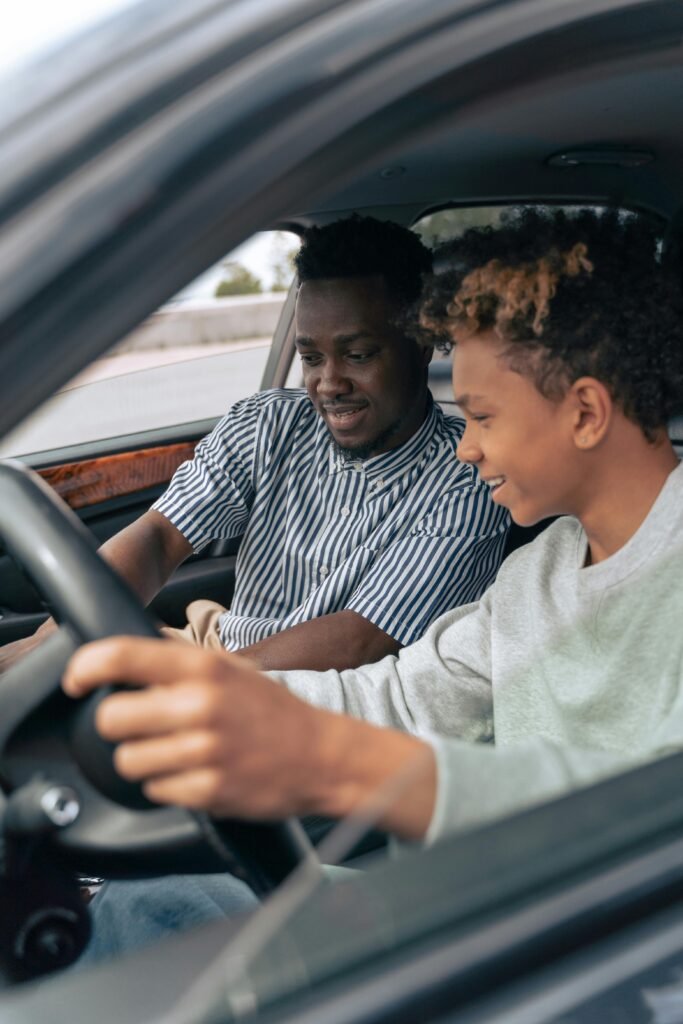 Father and son navigating safety feature of a vehicle